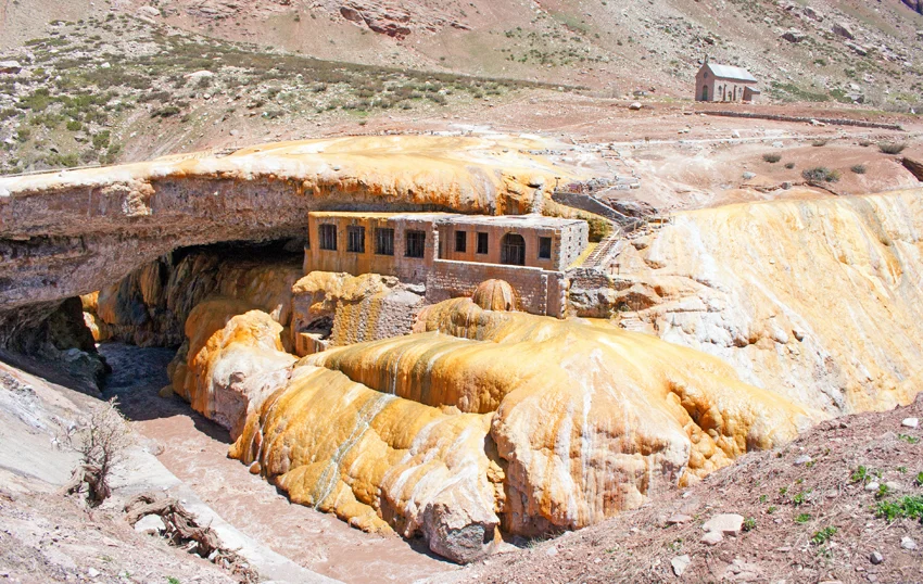 Puente del Inca arch over Las Cuevas river and abandoned spa hotel in Argentina