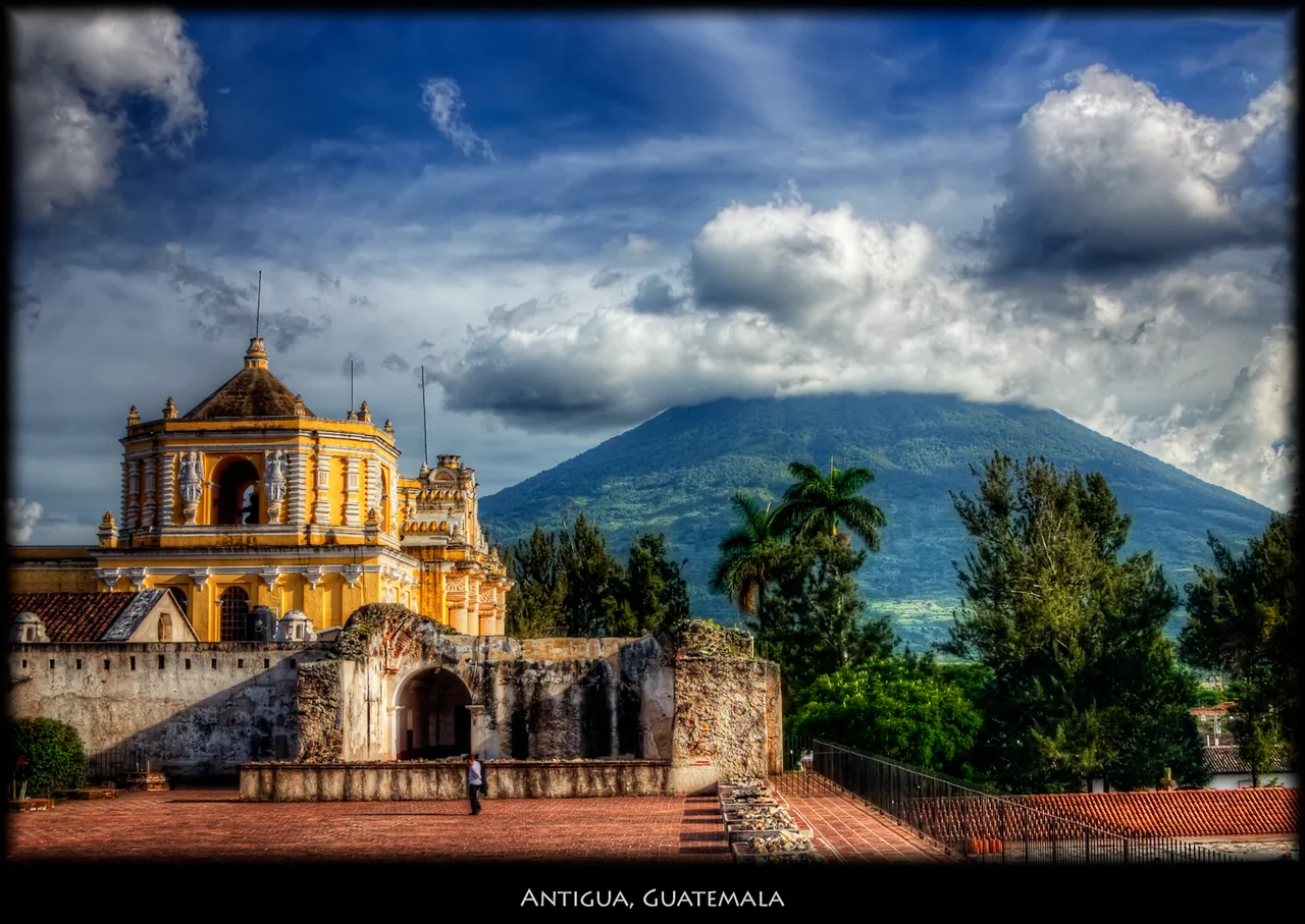 Volcan de Agua (Water Volcano) is one of three volcanos surrounding Antigua. I think the yellow building is one of the famous convents, and would appreciate it if someone tags the right name. This is pretty much what you come to Antigua for, beautiful buildings, the incredible surroundings and nice, friendly people. Nicer large.. See my Tikal shots.
ISO 100, 28mm, f7.1, 1/100. Tonemapped in Photomatix using Details Enhancer. Nik Pro Contrast, Tonal Contrast on the church and volcano, Vivezza to brighten the sky.