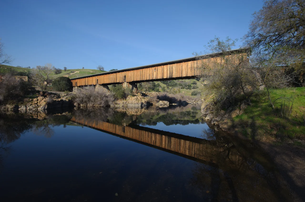 Knights Ferry covered bridge — crossing the Stanislaus River in Knights Ferry, California.
The longest covered bridge west of the Mississippi River, at 330 feet (100 m) in length.
A California Historical Landmark, and a Knights Ferry Historic District contributing property on the National Register of Historic Places.