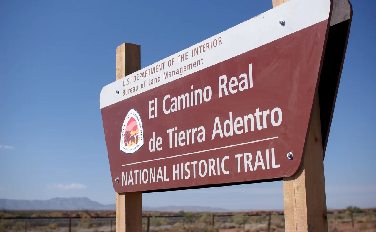 The Yost Escarpment Trailhead sign, just off of Upham Road east of Truth or Consequences, New Mexico, and a mile south of Spaceport America.
The El Camino Real de Tierra Adentro (Spanish for "The Royal Road of the Interior Land") is an ancient travel route between Santa Fe and Mexico City, whose use started in the late 16th century. The portion that travels through New Mexico passes through an arid desert known as the Jornada del Muerto (Spanish for "Journey of the Dead Man"), within which was recently created a National Historic Trail. Portions of this trail are open for hiking.
