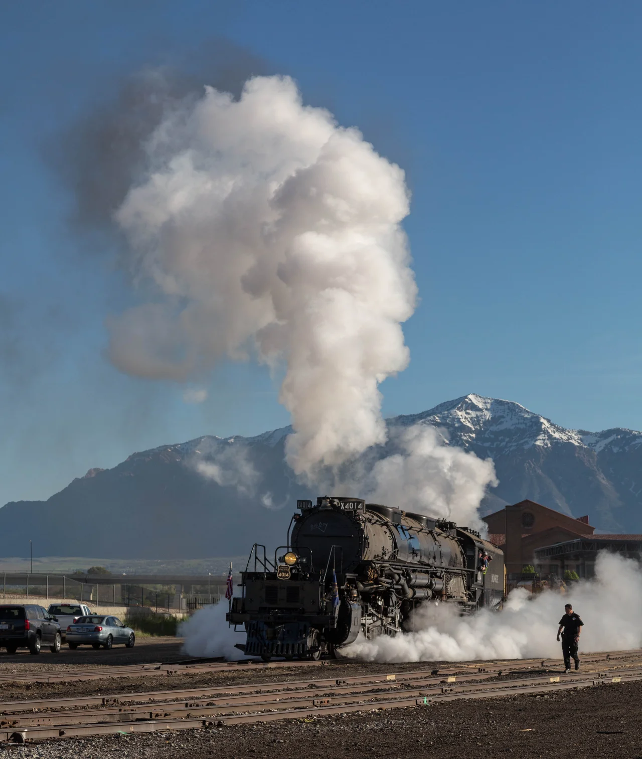 Union Pacific 4014 teamed with UP 844 take off from Ogden, Utah Union Station heading for Cheyenne, Wyoming after participating in the Golden Spike Sesquicentennial. Security guard is keeping us all at bay.