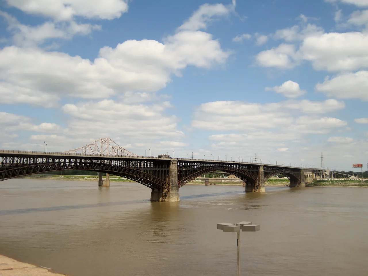 Eads Bridge in St. Louis, a national landmark (1874). After the Civil War, St. Louis began a sharp economic decline. Once a critical stop for commerce travelling on the Mississippi River, St. Louis became less relevant as trains became the main method of cargo transport. It became critical to the future of the town to bridge the Mississippi and become a gateway to the West. Designed by James B. Eads, the Eads Bridge was the longest arch bridge in the world when it was completed in 1874. Its steel cantilever design influenced bridge design for decades. The Gateway Arch was later based on this design.