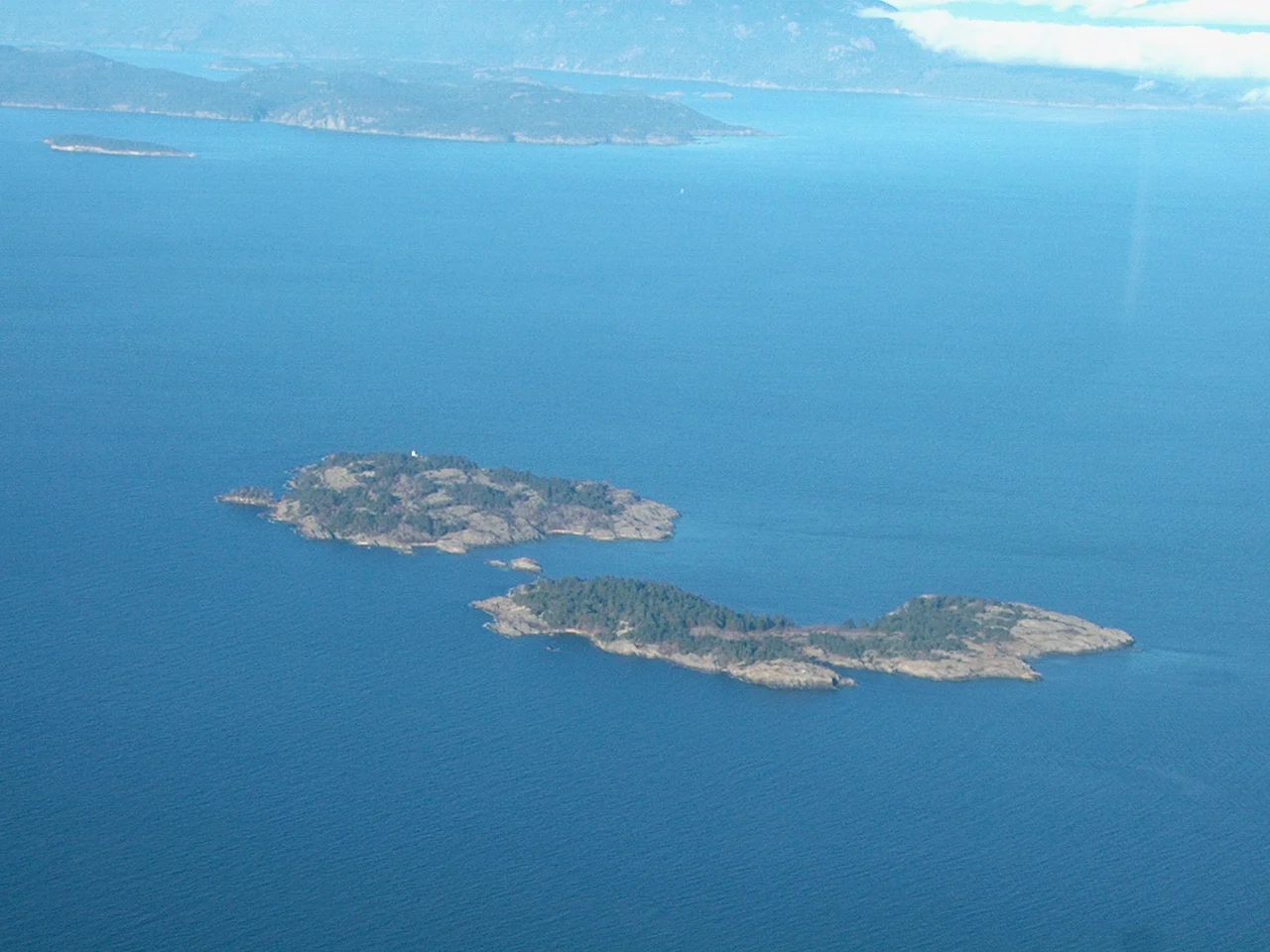 Aerial photograph I took myself of Ballenas Islands in the Strait of Georgia. Ballenas Light is on the top Island of the pair in the foreground. You can then see Sangster, then Lasqueti and then Texada Islands in the background. These islands are in the Straits of Georgia between Vancouver Island and mainland British Columbia, Canada. This photo is taken facing North.