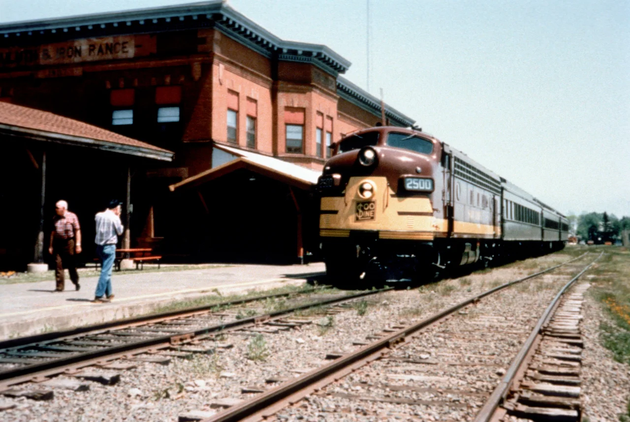 Scope and content: The original finding aid described this photograph as:
Original Caption: The North Shore Scenic Railroad, running between Duluth and Two Harbors is a popular tourist attraction during the summer and fall seasons. Passengers walk around the historic depot area as they wait to board the train.
Location: Minnesota (47.019° N 91.685° W)
Status: Public domain. Lake County Historical Society
