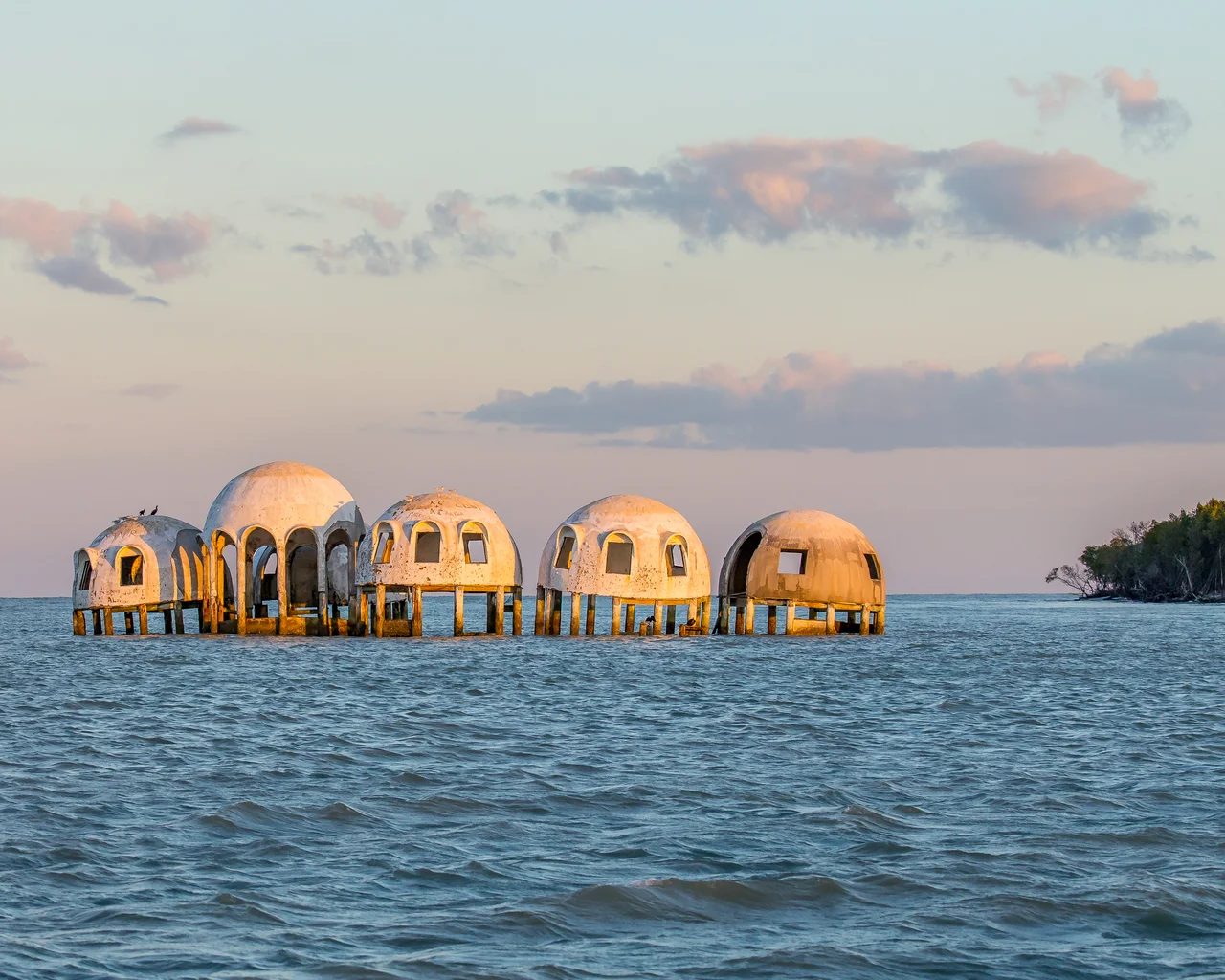 In the 1980s the Cape Romano Dome House was an ultra-modern dwelling built on a beach on an island. The forces of nature combined to leave the house standing in the sea, slowly falling apart. This strange sight can be seen near Marco Island, Florida.