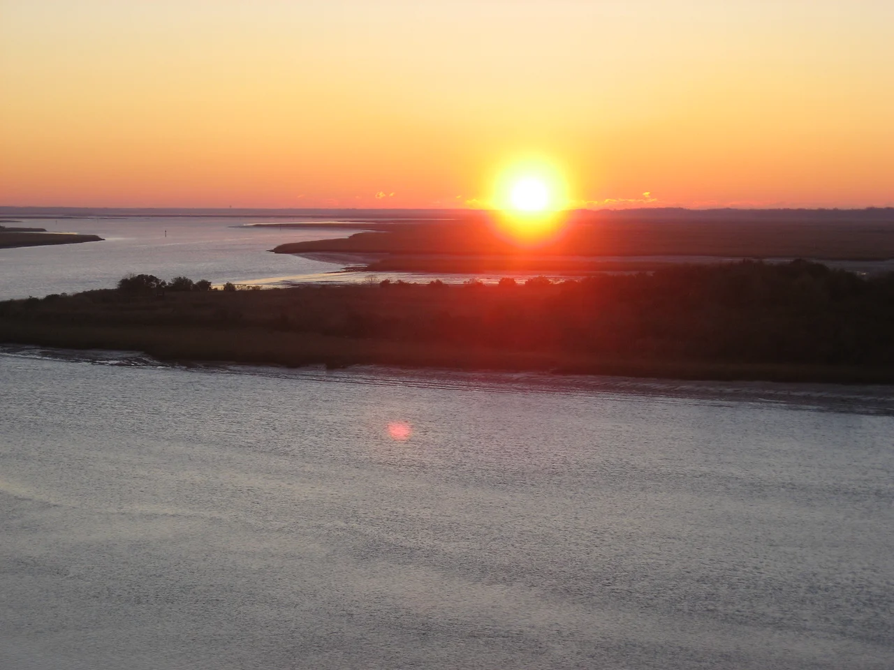 Scope and content: The original finding aid described this photograph as:
Original Caption: The sun rises casting orange, red, and pink light across the Intracoastal Waterway along the Edisto Island National Scenic Byway.
Location: South Carolina (32.599° N 80.346° W)
Status: Public domain.
