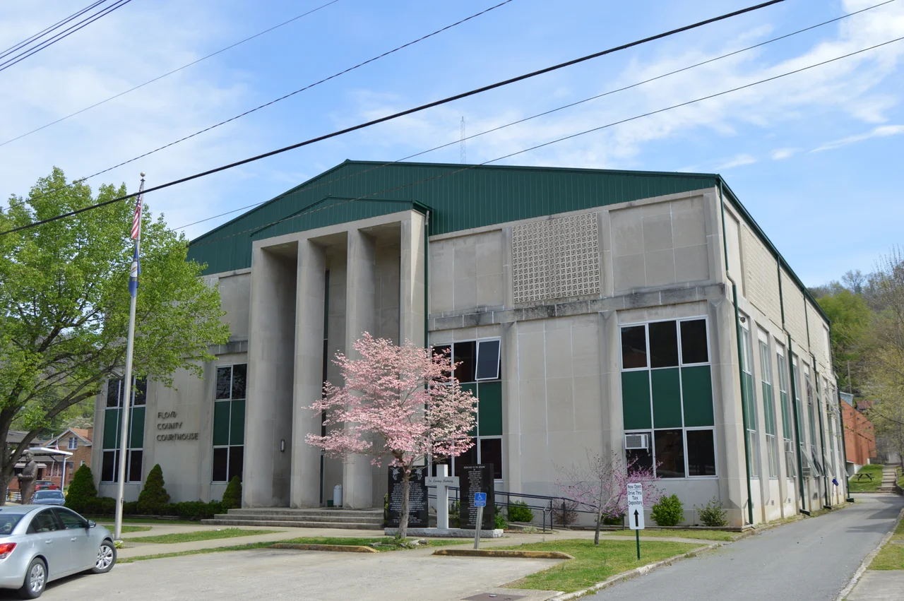 Front and southern side of the former Floyd County Courthouse, located on Third Avenue in downtown Prestonsburg, Kentucky, United States. It was built in 1964. The cross and black stone markers in front of the courthouse are a memorial to the victims of the Prestonsburg bus disaster of 1958.