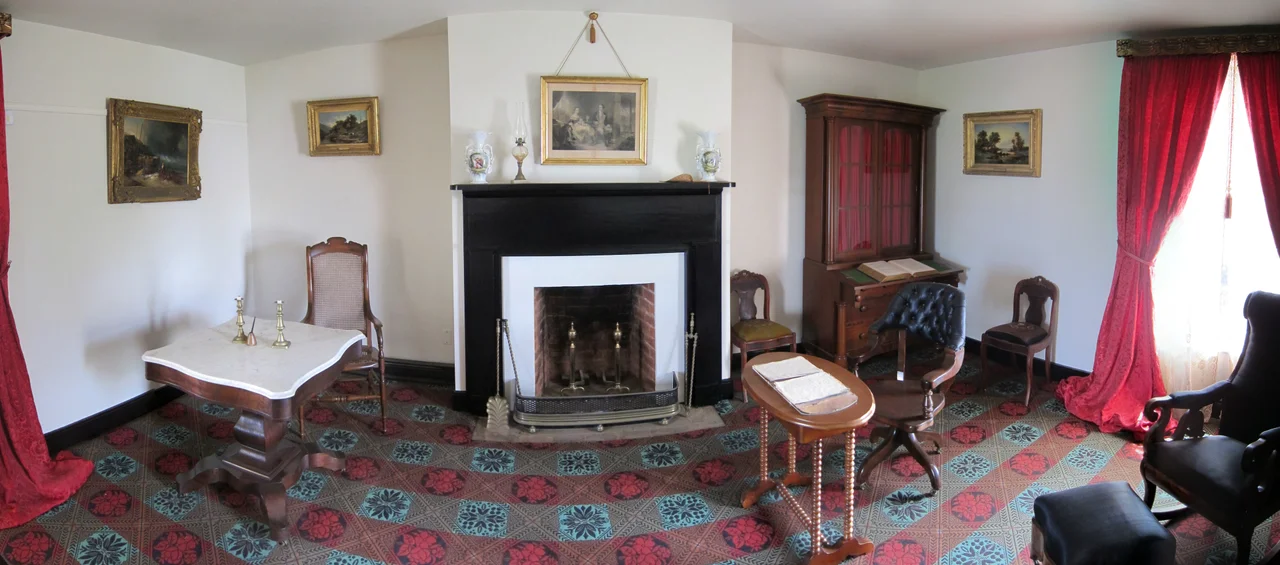 A panoramic image of the parlor of the reconstructed McLean House in Appomattox Court House National Historical Park as seen in August 2011. The house was originally built by Charles Raine in 1848, and was the site of the surrender of the Army of Northern Virginiato the Union Army on April 9, 1865. Ulysses S. Grant sat at the simple wooden table on the right, while Robert E. Lee sat at the more ornate marble-topped table on the left. The furniture pictured are replicas of the originals, which are kept at the Smithsonian Museum.