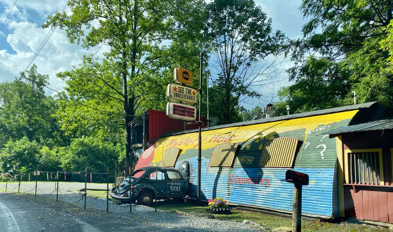 View of the building and "crashed" VW beetle at the "Mystery Hole" tourist attraction located by US Route 60 (Midland Trail" near Ansted, West Virginia.