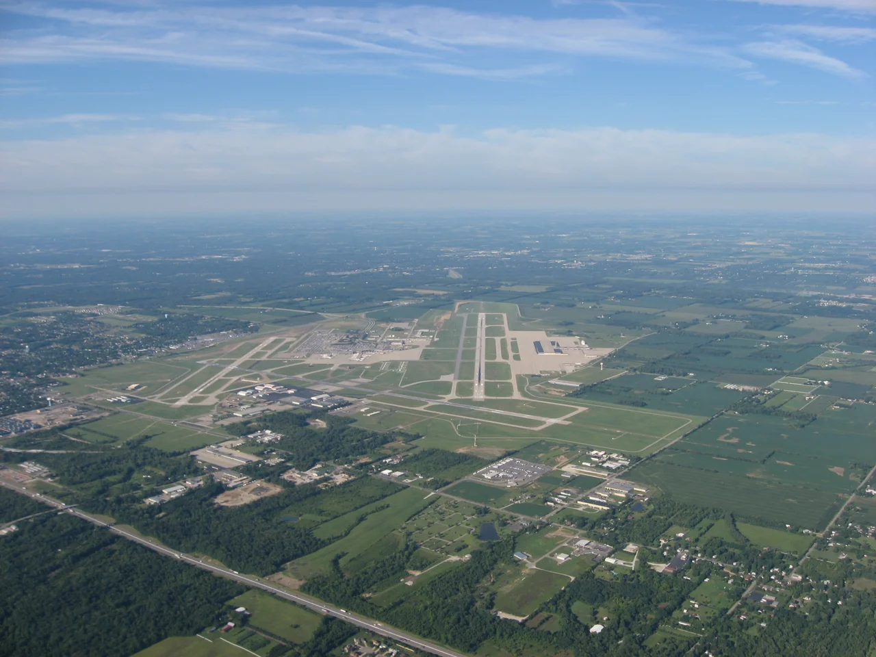 Aerial view down Runway 24R of the James M. Cox Dayton International Airport in Vandalia, a northern suburb of the city of Dayton, Ohio, United States. Picture taken from a Diamond Eclipse light airplane at an altitude of 4,480 feet MSL and a bearing of approximately 235º.