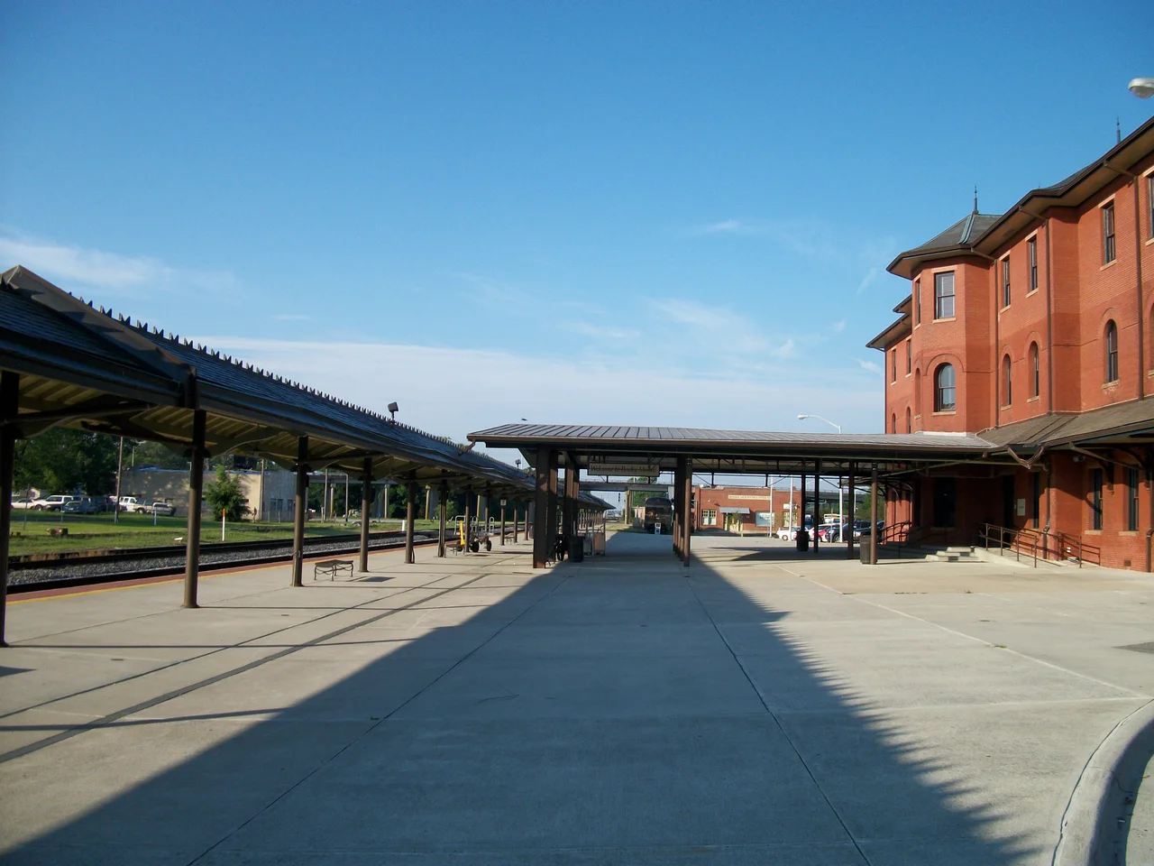 South view of the historic Helen P. Gay Rocky Mount (Amtrak station) in Rocky Mount, North Carolina canopies along the platform as taken from the corner of Nothwest Main Street and Hammond Street. Originally a Wilmington and Weldon Railroad then acquired by the Atlantic Coast Line Railroad, and restored for Amtrak. This shows three of the four stories of the station house and the two canopies along the platform, one of which leads directly to the station. This is a better shot of the canopies than the one I took of File:Rocky Mount Amtrak; Northwest View.JPG, but it doesn't show all four floors.