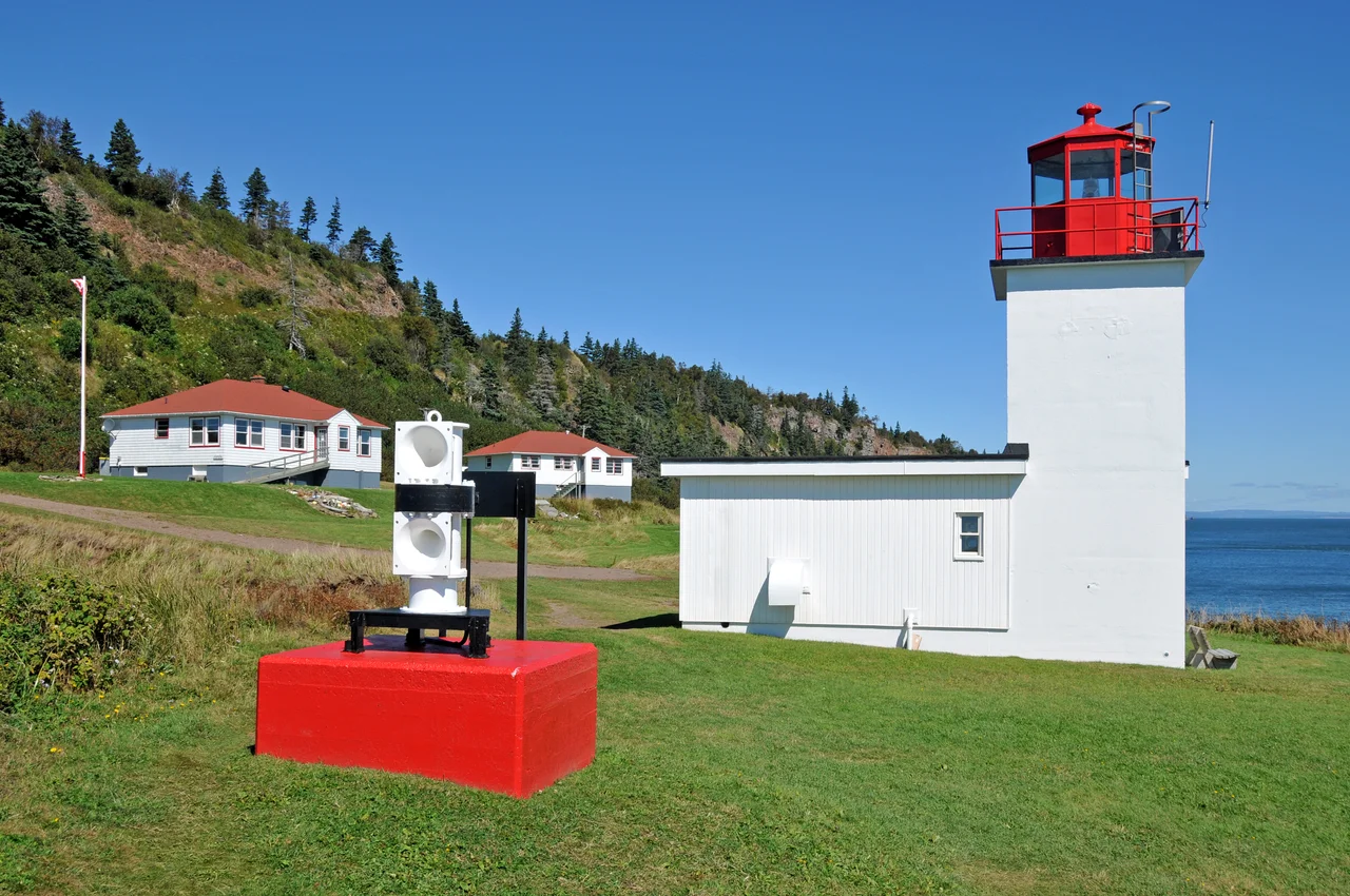 French explorer Smauel de Champlain named Cape D’Or (Cape of Gold) when he sailed by here in 1607. Originally established as a fog horn station in 1875, the Cape d'Or lightstation is perched halfway up the dramatic cliffs rising out of the turbulent Minas Channel. The cape received its first lighthouse in 1922.
The present lighthouse, is a one-story fog signal building with a light tower rising from one corner, it was built in 1965. After automation in 1989, the two keeper’s dwellings, completed in 1959, sat vacant until being leased by the Advocate District Development Association in 1995 and converted into a tearoom and hostel.
This is the only lighthouse in Nova Scotia to offer overnight accommodations.
