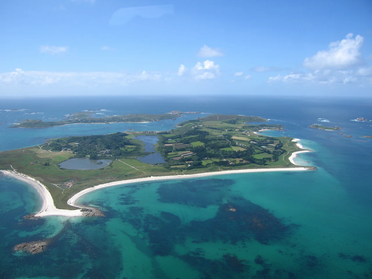 Looking across Tresco, one of the five inhabited islands of the Isles of Scilly 45 km (28 miles) from the coast of Cornwall in the United Kingdom. Photo taken from a helicopter using a Canon PowerShot S70 camera in June 2005.