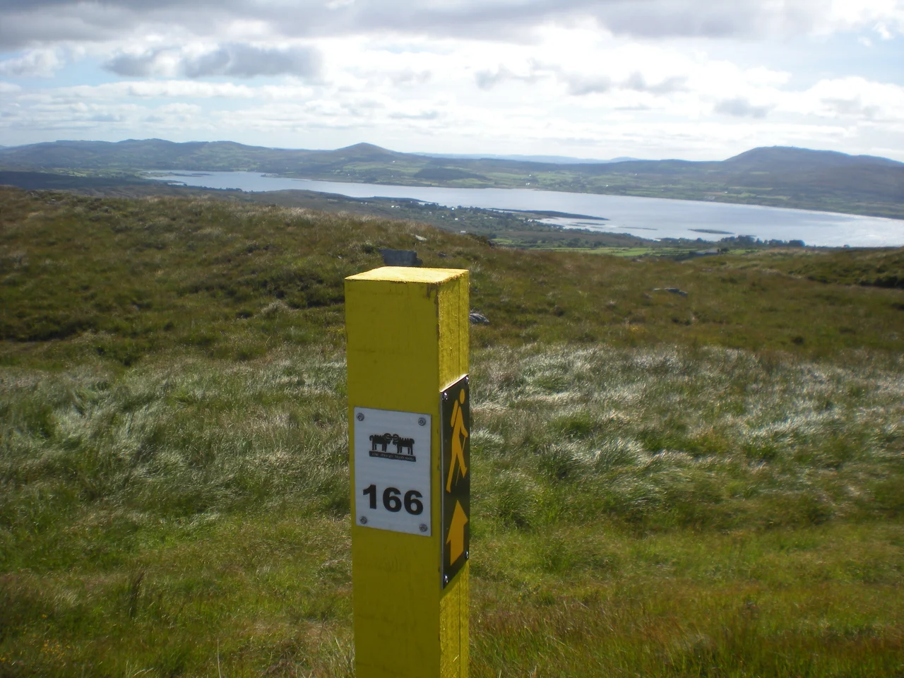 A Marker of the Sheep's Head Way, taken on top of Seefin Mountain, Sheep's Head Peninsula, County Cork, with a view of Dunmanus Bay in the background.
