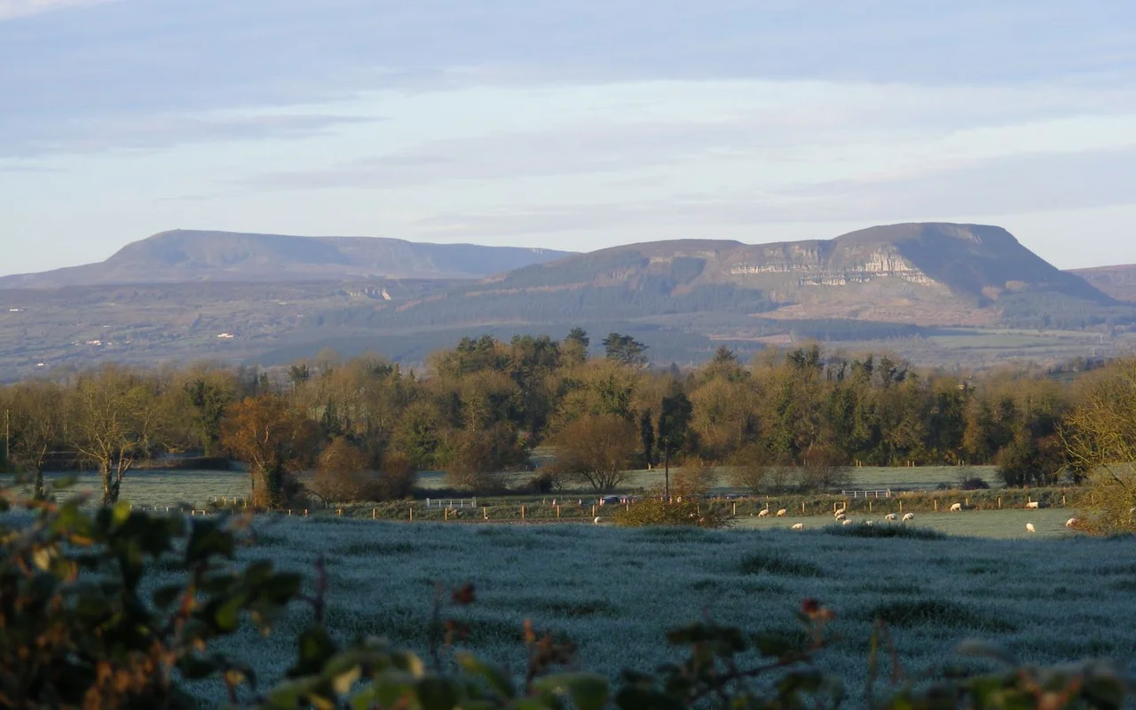 Cuilcagh & Benaughlin mountains in Fermanagh/Cavan, November 2007. Cuilcagh can be seen on the upper left and the cairn is visible. Cuilcagh is roughly twice the height of Benaughlin.
