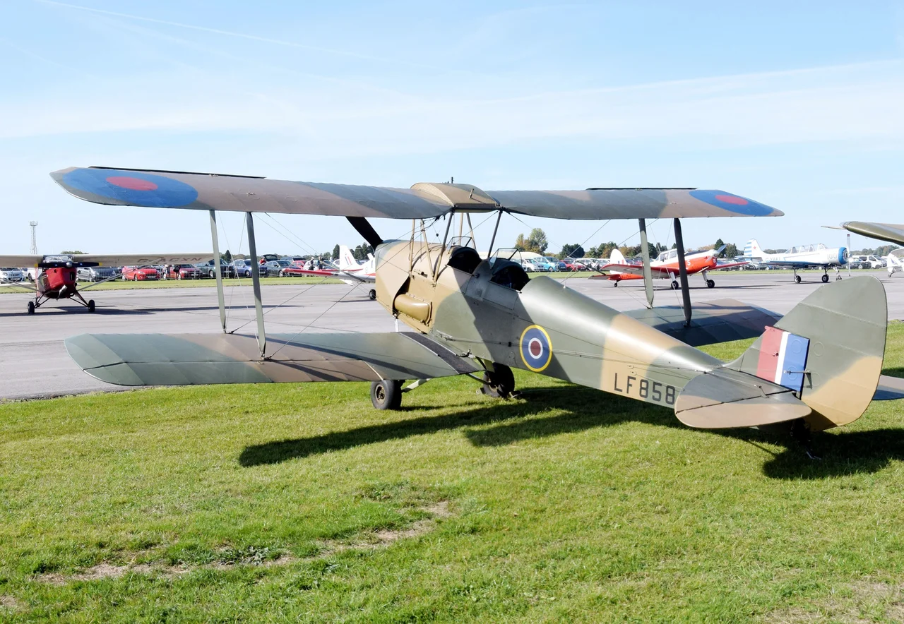 ex-RAF de Havilland DH-82B Queen Bee on static display at the 2018 Cotswold Airport Revival Festival, Gloucestershire, England. Built 1944 in Glasgow as Royal Air Force LF858, now privately owned as G-BLUZ. The fuselage is from a Moth Major and the wings from a Tiger Moth. Over 400 were built. It was flown remotely by a pilot on the ground (no one was onboard!) as a gunnery target. Now converted from remote control to a 2-seater. Kept at RAF Henlow (Bedfordshire) in the ownership of a private syndicate (the Beekeepers Group).