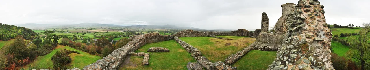 270° panorama inside the ruins of the Montgomery Castle, Wales. This panorama shows the castle walls and grassy interior courtyards as well as views of the Welsh countryside as seen on a rainy October afternoon. Photo by Gregg M. Erickson