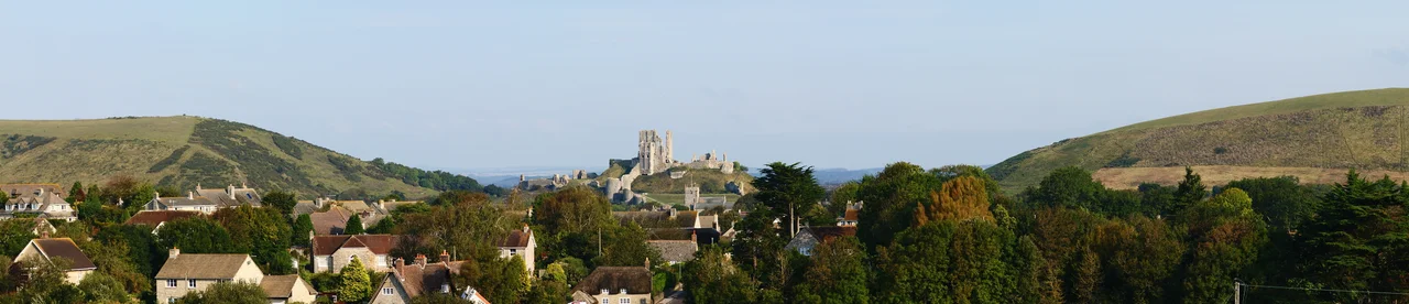 A panorama showing Corfe Castle & its setting in Dorset, UK.