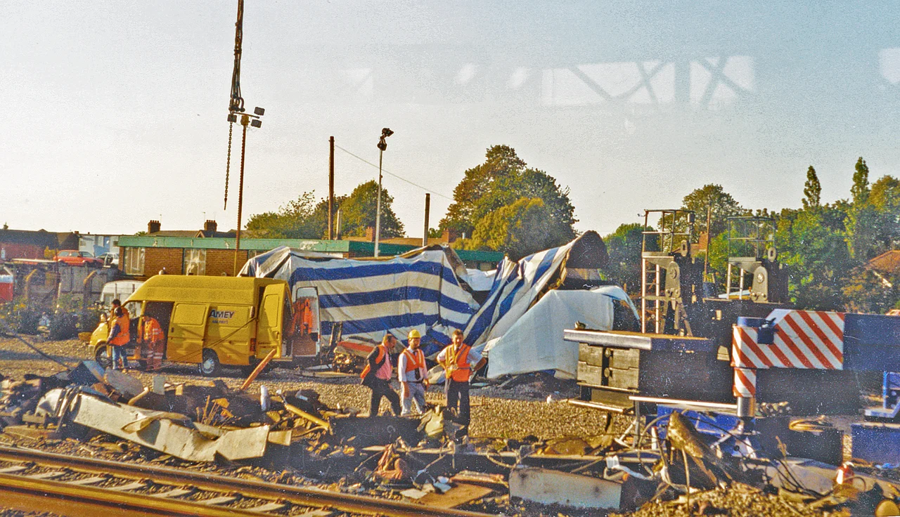 Southall Rail Crash, 1997.
View NW from a passing train: ex-GWR Paddington - Reading main line, just east[?] of Southall Station. Four days before, a High-Speed Train from Swansea, with defective Advanced Warning System (AWS) had collided at high speed with an empty stone train being shunted across its path - protected by adverse signals. The consequences, including seven people killed, were horrific. [Precise location uncertain?]