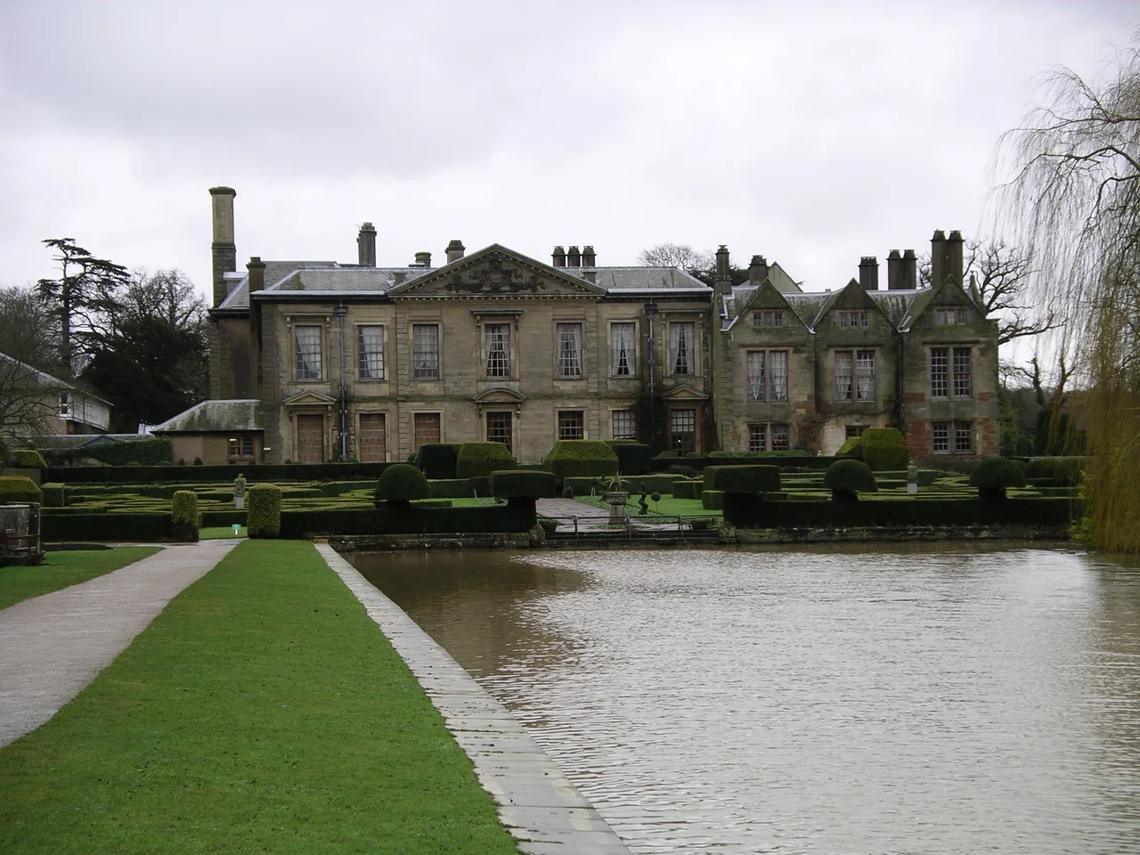 Photo of the West Wing, lake and gardens at Coombe Abbey Country Park, Warwickshire, England.