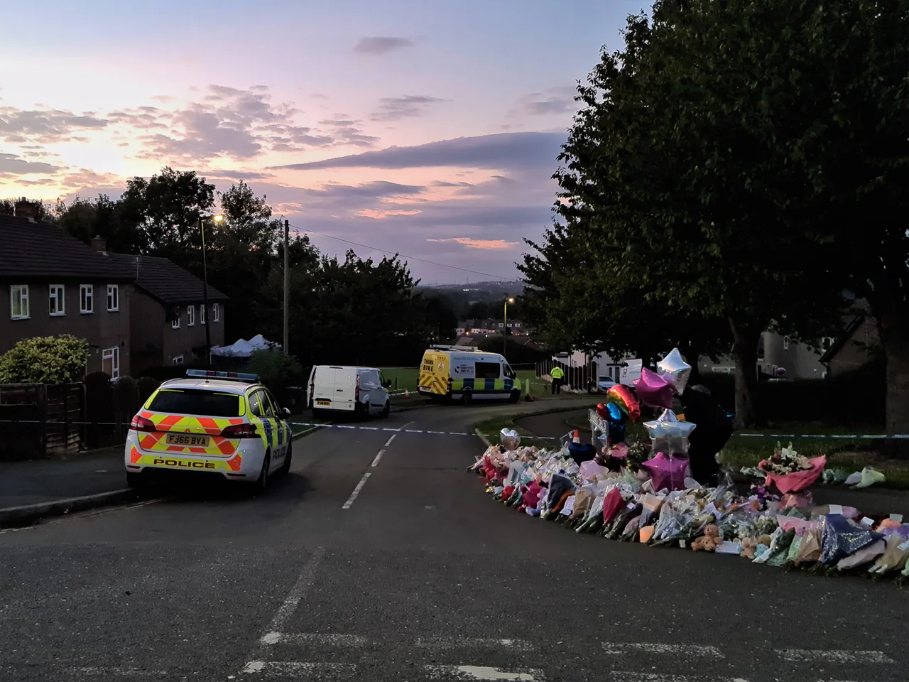 Flowers and balloons left at the police cordon on Chandos Crescent, Killamarsh, Sheffield following the murder of three children and one adult at a residential property on 19 September 2021. Photo taken at sunset on 23 September 2021.