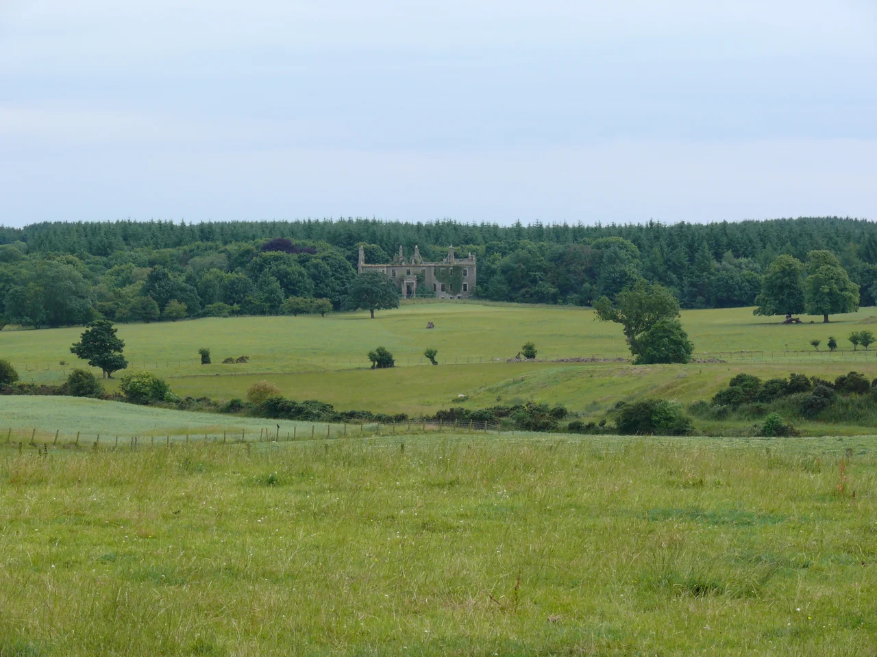Barnbarroch House. by Andy Farrington. View across open fields to the house which burnt to the ground in 1941 and remains a ruin.