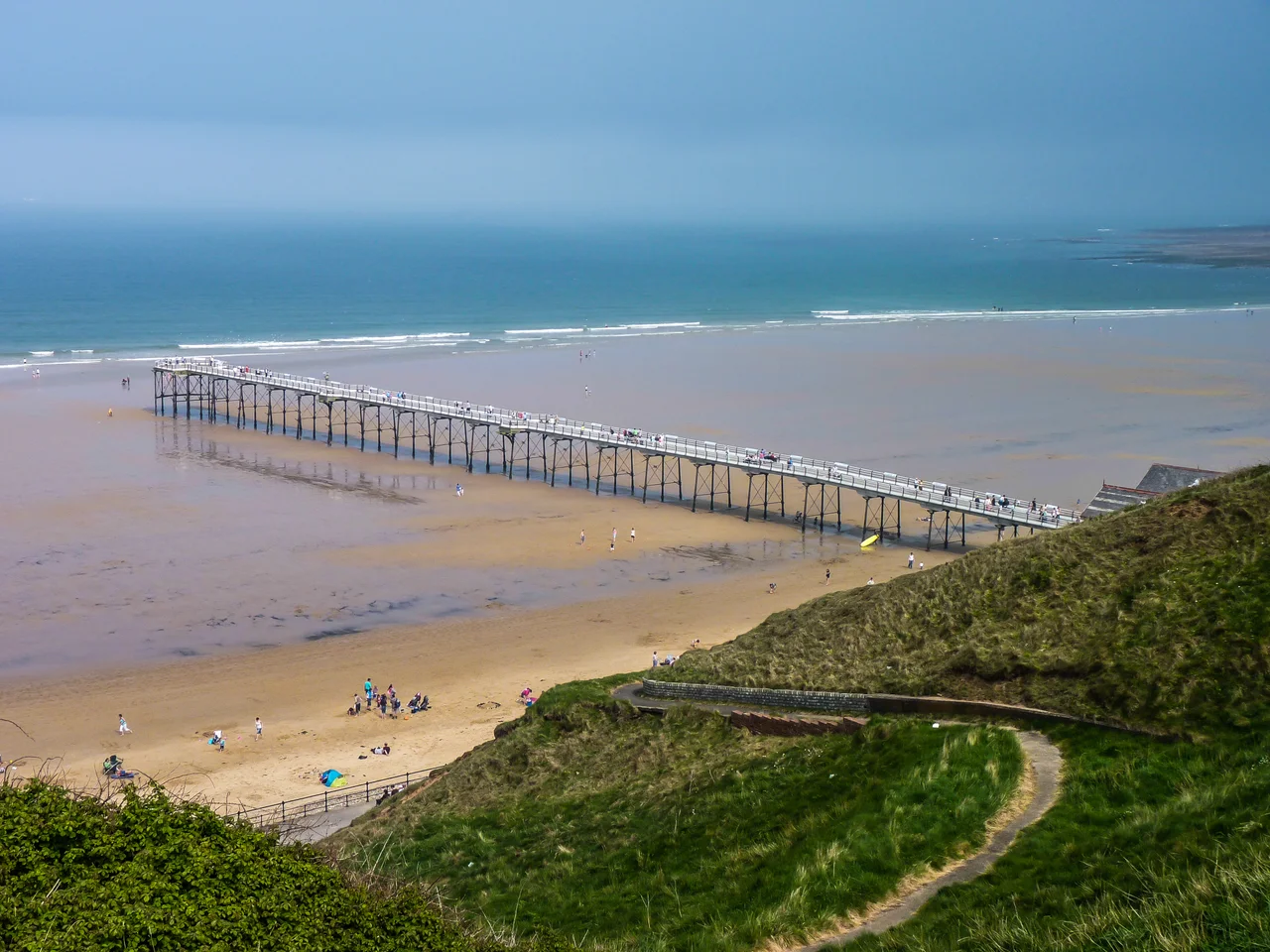 A view of Saltburn Pier taken from the pathway on the hillside.