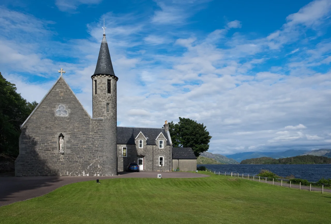 The Roman Catholic church of Our Lady of Perpetual Succour & St Cumin in Morar, Scotland. This church lies on the banks of Loch Morar, which with a maximum depth of 310 m, is the deepest body of freshwater in the British Isles.