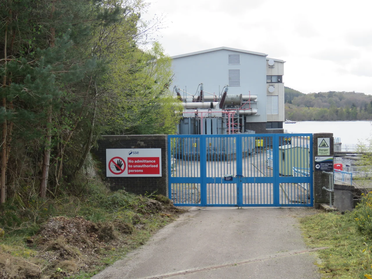 The north gate to the Foyers 300MW power station, showing part of the main building and the transformer station. An underground cable connects this to the 275kV switching station some 3000 feet (910 m) to the north.