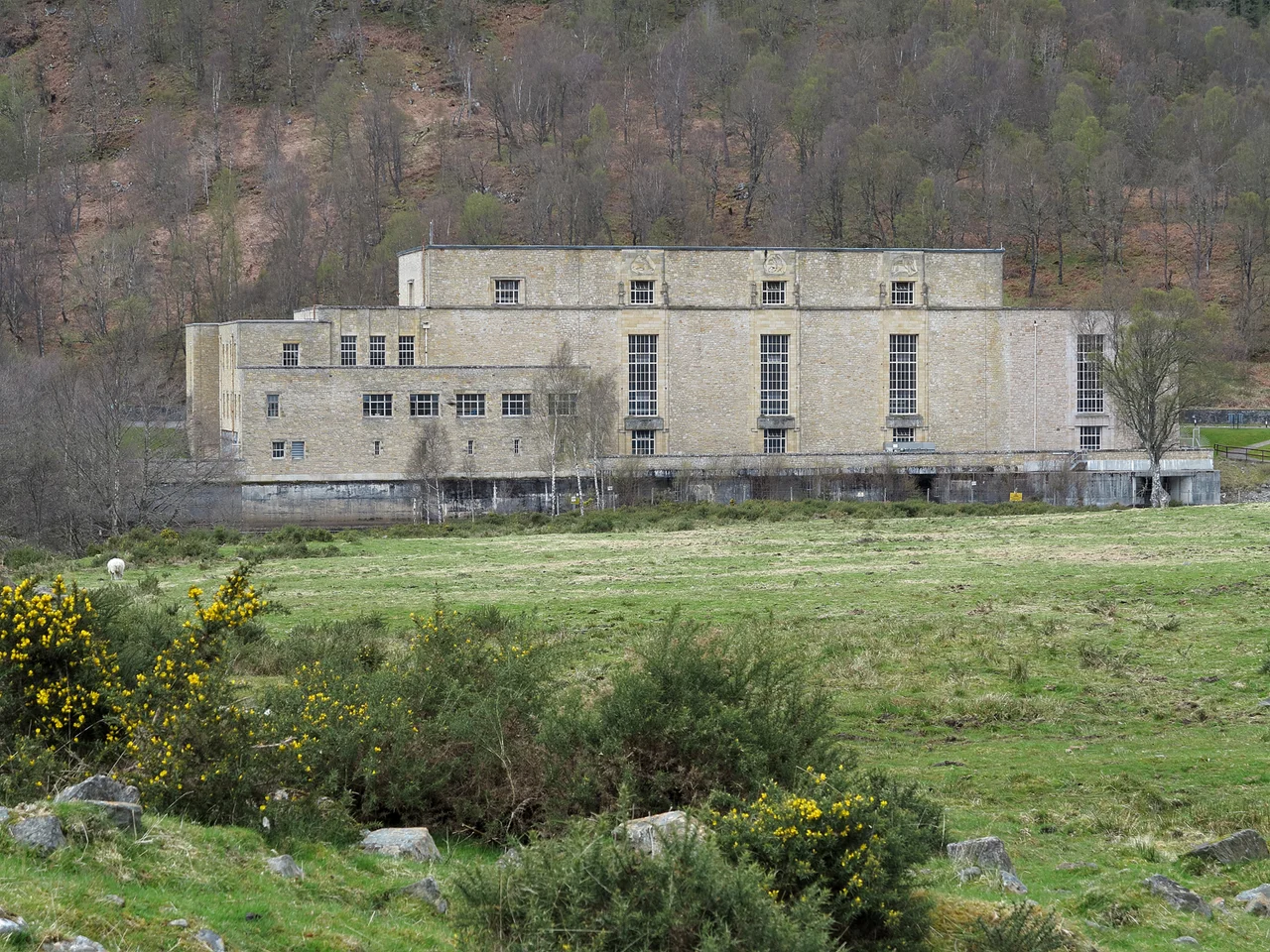 Rough grazing with power station beyond From Cannich, a minor road leaves the A831 to reach the small settlement at Tomich; this view is from that road, across a field, towards the Fasnakyle Power Station.