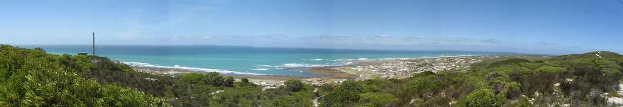 Panorama at Cape Agulhas around the southernmost tip of Africa. The parking area with the marker for the southernmost point is visible in the near right. Taken from the lighthouse.