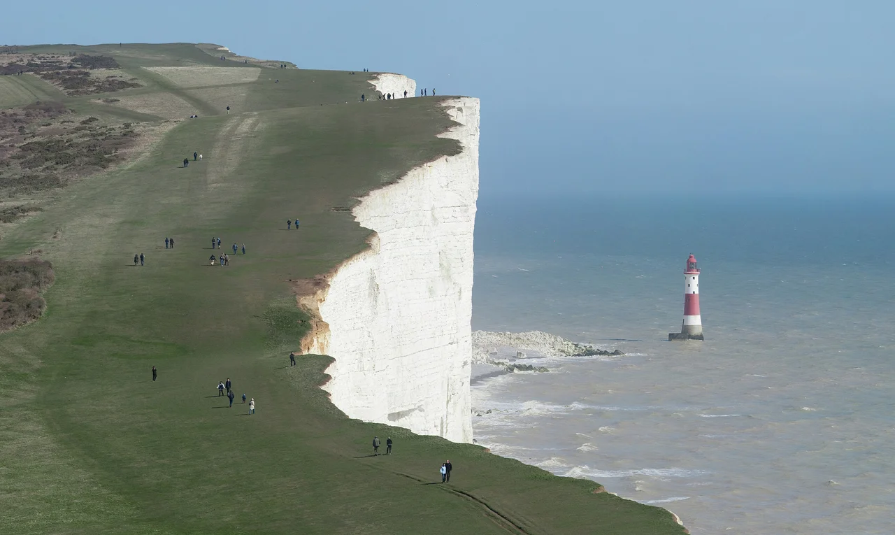 The cliffs of Beachy Head and the Lighthouse below, as viewed along the South Downs Way in East Sussex, England.