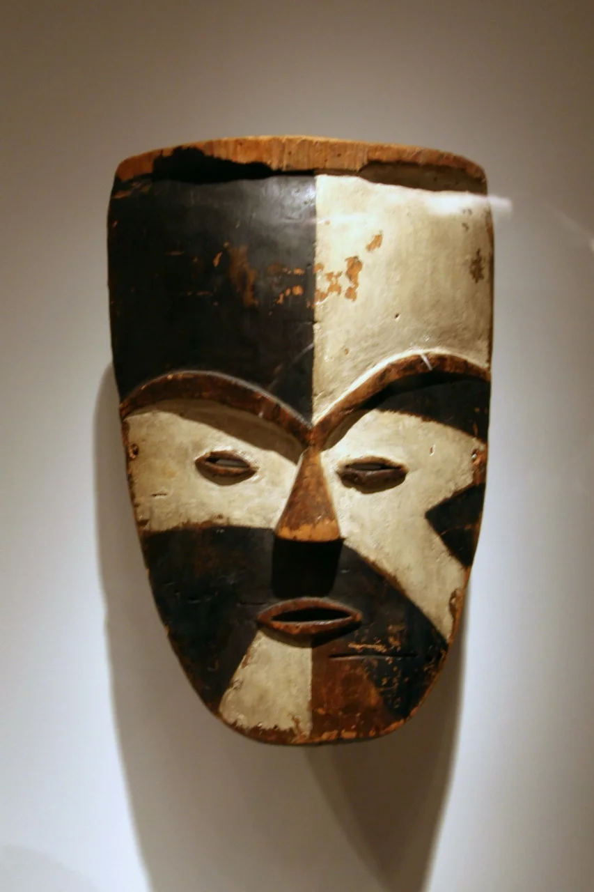 Mask, Tsogo peoples, Ogowe River region, Gabon, Late 19th to early 20th century, Wood, pigment
The striking disconnect between the divisions of the painted surface and the underlying carved form is an aspect of African art that first entranced Western audiences. The Western lack of awareness of context was such that when this mask was exhibited in the 1950s in France, it was identified as coming from another part of Africa. Later research attributed this mask to the Tsogo peoples as part of wider regional tradition of divided color faces.
(National Museum of African Art)