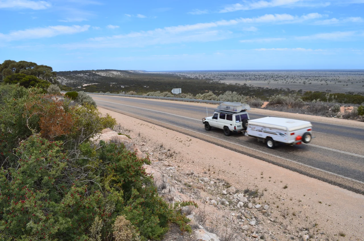 View of the Madura Pass on the Eyre Highway, Western Australia. At the foot of the escarpment at the centre left of the image is the Madura roadhouse, and in the background at right are the Roe Plains.