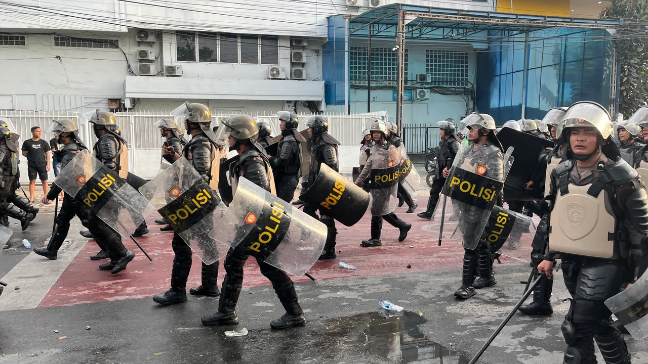 Riot police personnels passing by