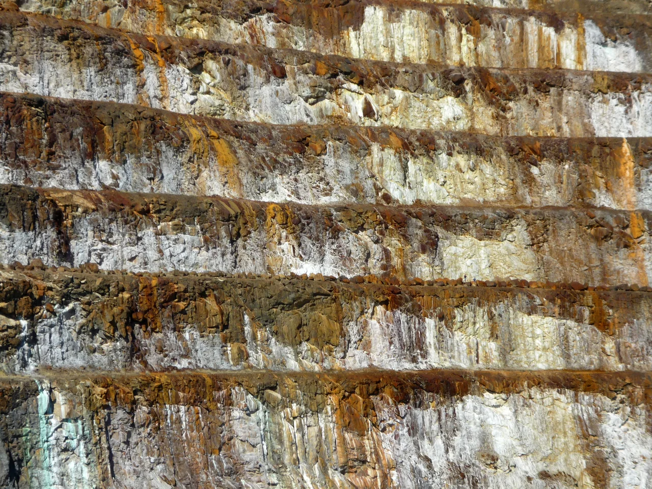 Photo of Mary Kathleen Mine close-up. Two people can be seen on the second terrace (from the bottom of the image) to the right of the image.