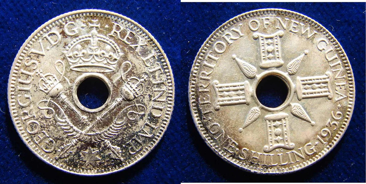 5.4 g Sterling Silver
George V, 1921- 1936
Hole in centre, flanked by crossed sceptres and crownabove Around: "* GEORGIUS V. D G REX ET IND. IMP. *"/ On the reverse the hole is flanked by indigenous designs, around: "TERRITORY OF NEW GUINEA ONE SHILLING date". KM 5
Medallist: KG (George Kruger Gray), 1880 London - 1943 Chichester, England.
Condition: Nicely toned EXTREMELY FINE.