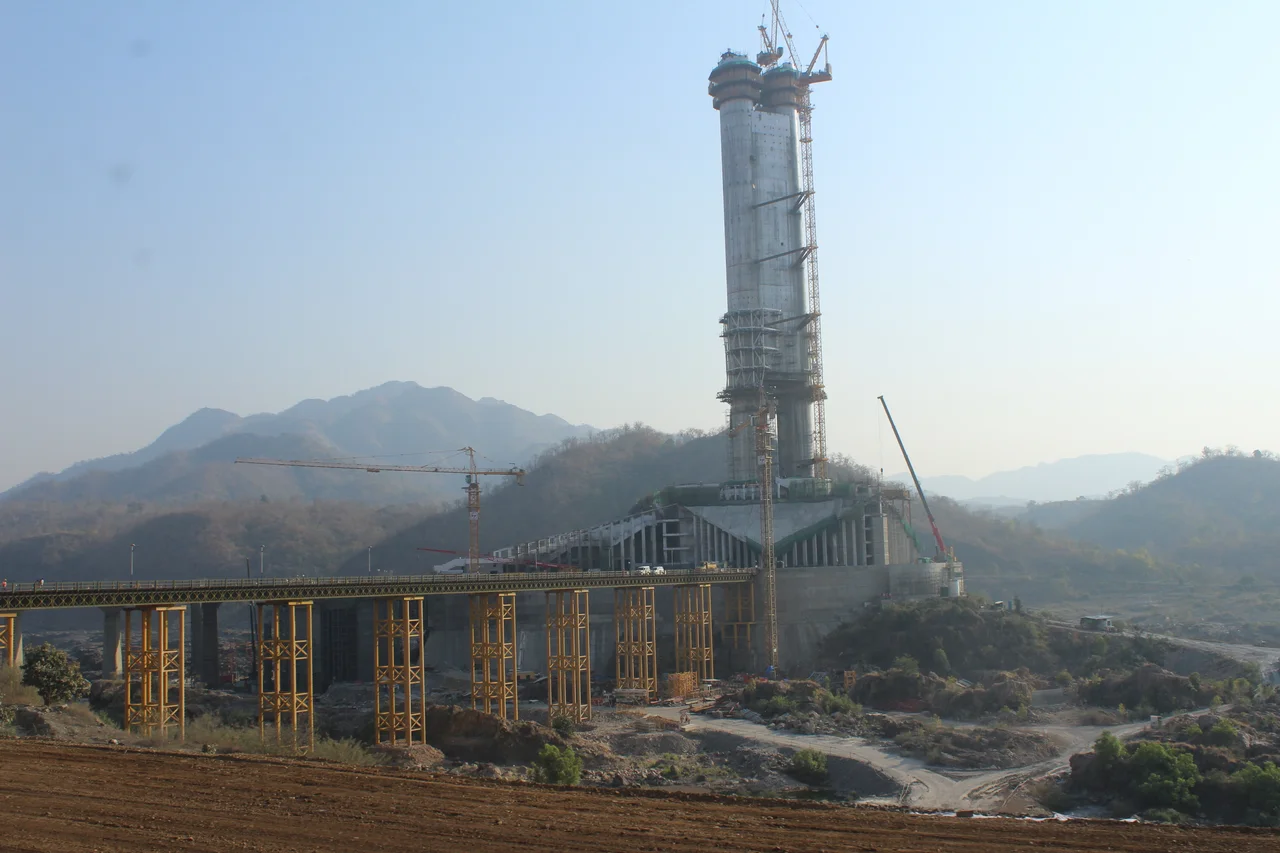 The Statue of Unity is the world's tallest statue with a height of 182 metres (597 ft). It is a colossal statue of Indian statesman and independence activist Sardar Vallabhbhai Patel (1875–1950) who was the first Home minister of India and the chief adherent of Mahatma Gandhi during the non-violent Indian Independence movement; highly respected for his leadership in uniting the 562 princely states of India to form the single large Union of India. It is located on a river island facing the Sardar Sarovar Dam on river Narmada in Kevadiya colony, 100 kilometres (62 mi) southeast of the city of Vadodara, Gujarat, India.