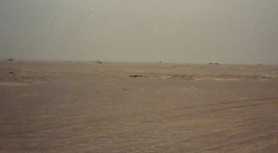 A Iraqi defensive position in Task Force 1-41 Infantry's sector of operations during the Battle of 73 Easting. The top of destroyed Iraqi tanks are visible as they sit in defensive entrenchments. More destroyed Iraqi armor sits in the distant background.