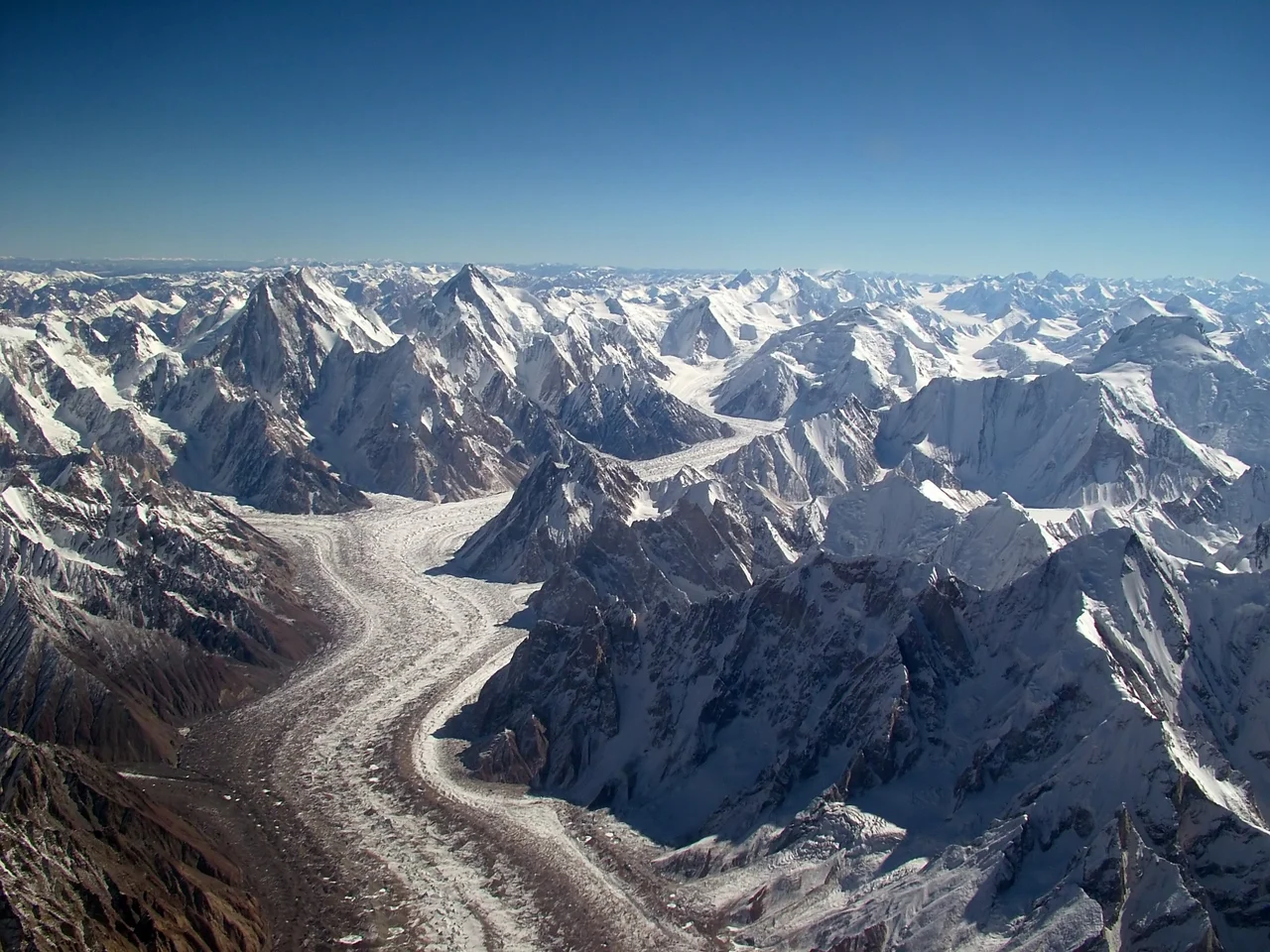 Aerial View of the Baltoro Glacier towards Concordia with Gasherbrum IV and Gasherbrum I on the left, Baltoro Kangri and Chogolisa on the upper right ; Mitre Peak is right in the center (where the glacier turns left while flowing down).