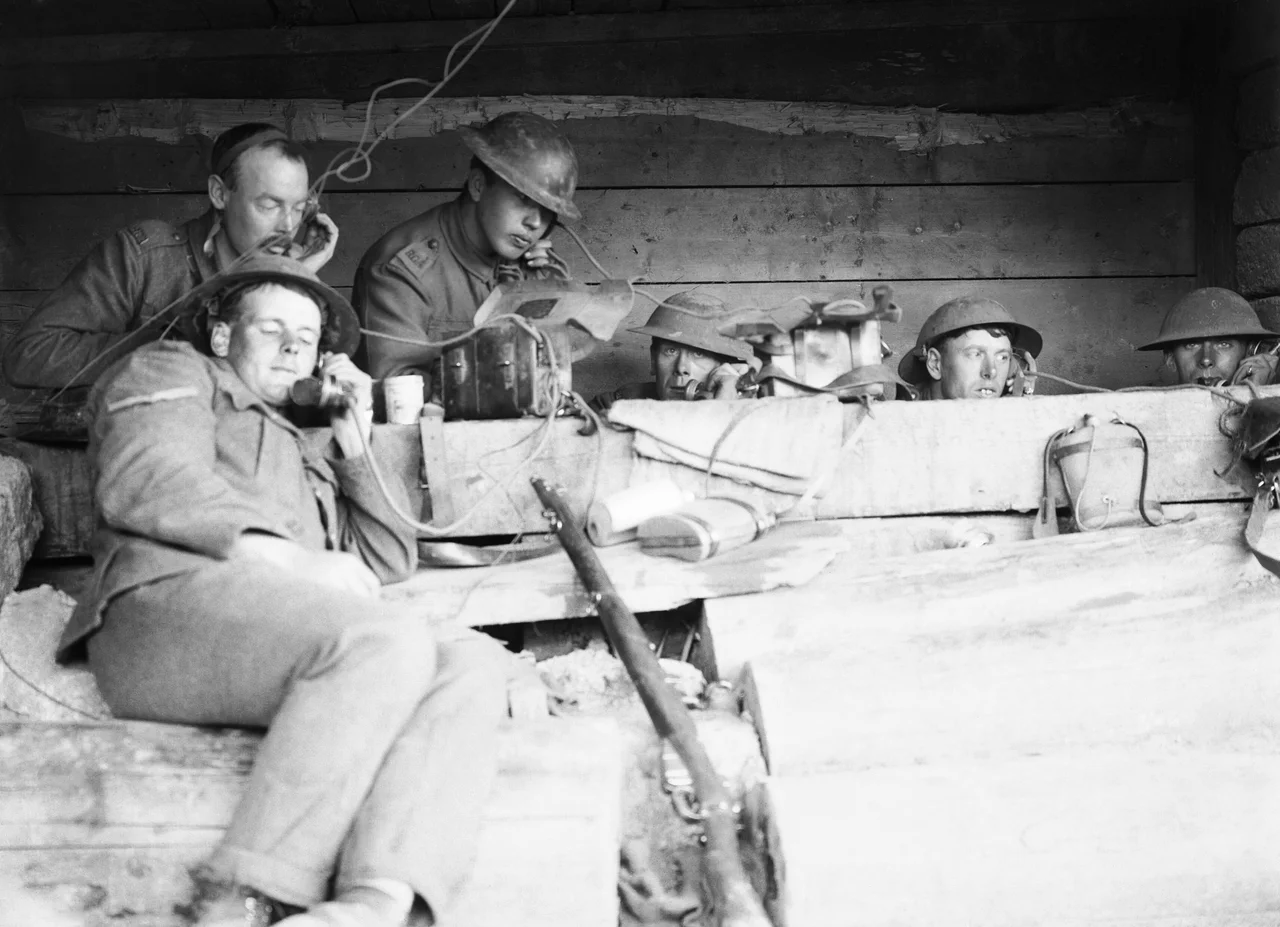 Battle of Langemarck 16-18 August 1917 : Royal Garrison Artillery telephonists at work passing messages from the forward observation officers to their batteries in a dug-out close to the front line near Langemarck, Belgium.