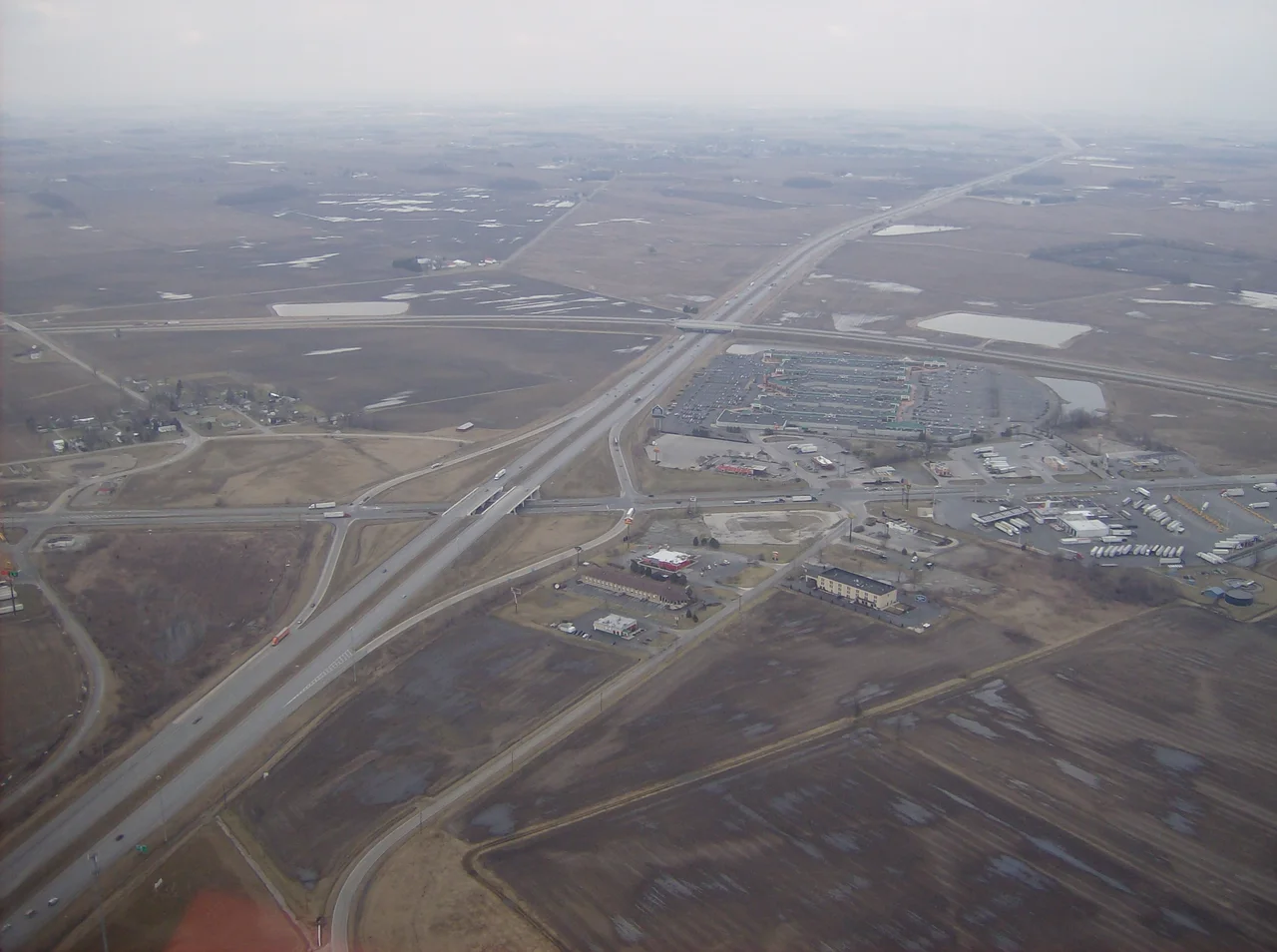 Aerial view of West Lancaster, a community in southern Jefferson Township, Fayette County, Ohio, United States. The village of Octa lies primarily just off the bottom edge of the picture, although its village limits extend along the road that appears from the picture's bottom edge. Picture taken from a Diamond Eclipse light airplane at an altitude of 2,500 feet MSL at an bearing of approximately 5º. The interchange is Interstate 71 over State Route 435, and the divided highway's overpass in the background is U.S. Route 35 passing over the interstate.