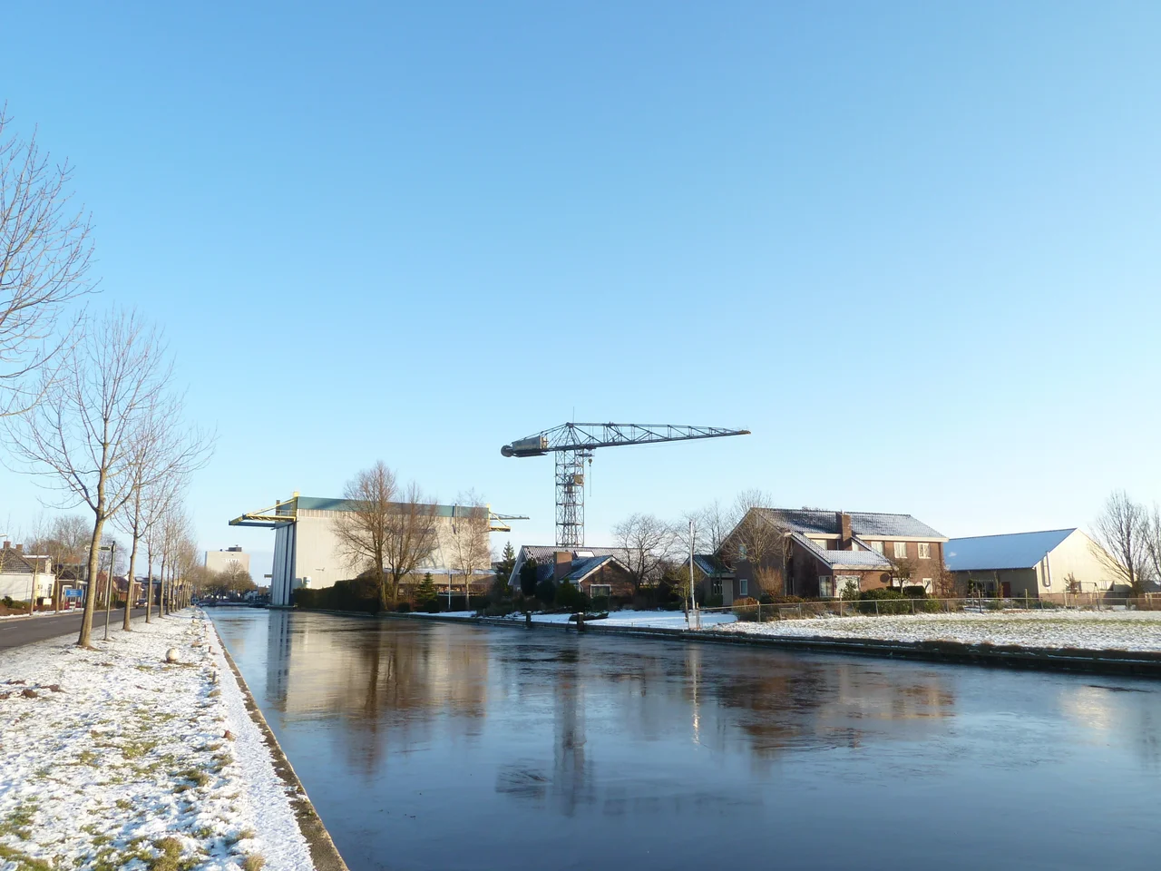 Oude Hoendiep in Stroobos met op de achtergrond de loods van mengvoederfabriek Sikma en op de voorgrond de loods van scheepswerf Barkmeijer.