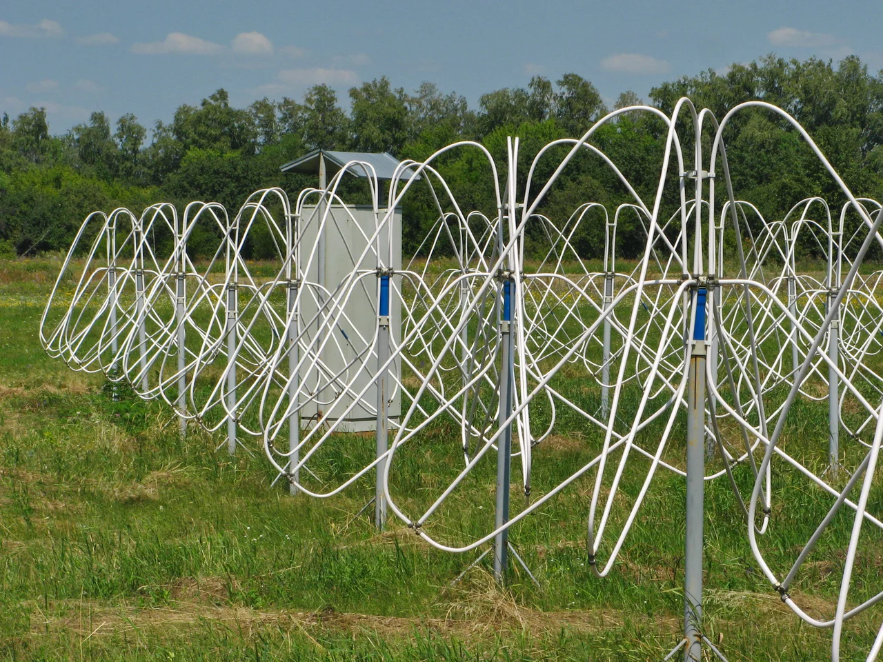 Some of the active dipole antennas of the Giant Ukrainian Radio Telescope  (GURT) operated by the  Institute of Radio Astronomy of the National Academy of Sciences of Ukraine, located in the Kharkiv region, Ukraine.  It is a phased array radio telescope which receives  radio waves in the range 8-80 MНz emitted by aatronomical objects in the sky.  The basic antenna unit, shown here, is a 5x5 array of 25 crossed dipole antenna elements mounted 1.6 m above the ground, with a separation of 3.75 m.  Many of these subarrays are scattered over the landscape.